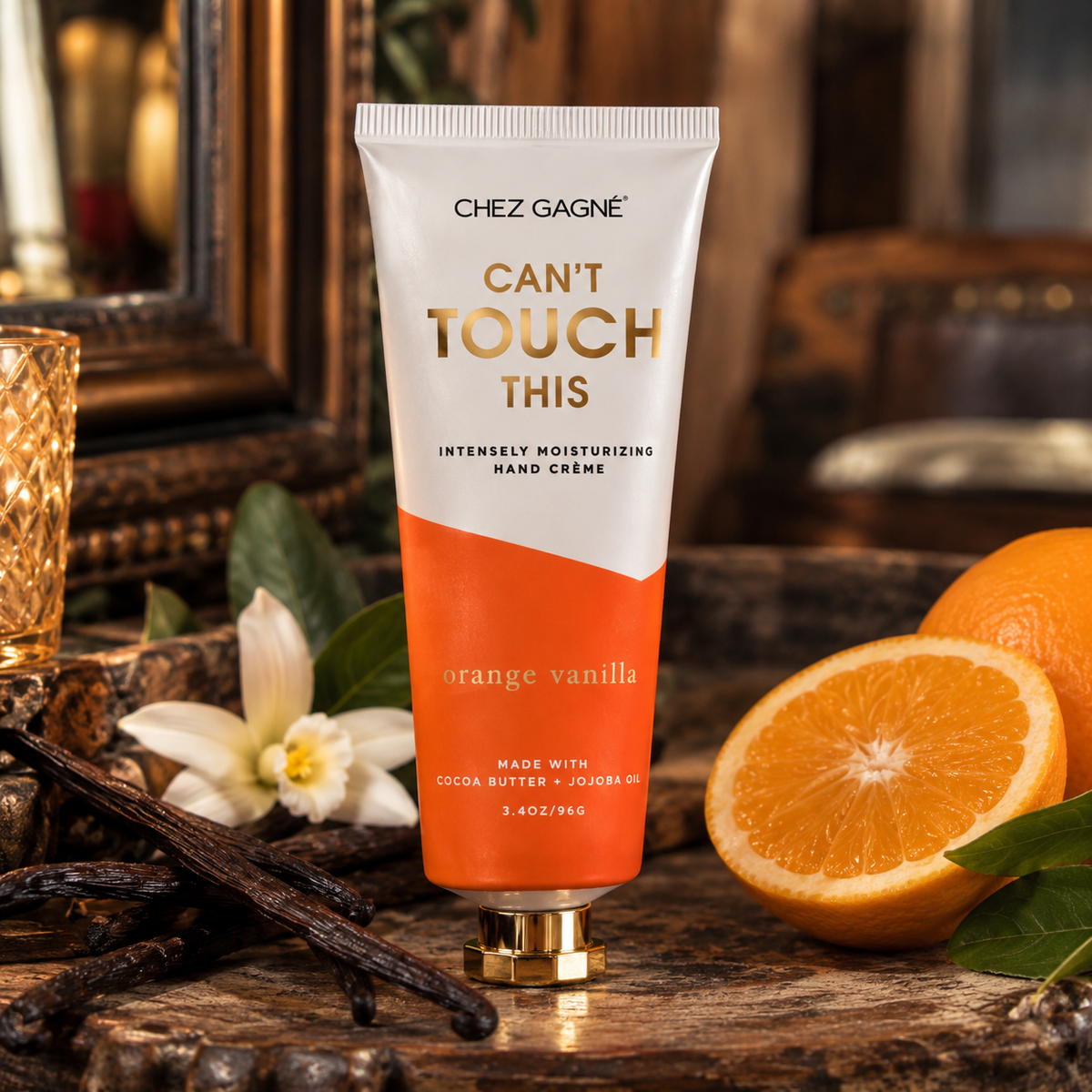 Chez Gagné Can't Touch This Orange Vanilla Hand Crème in a warm Madame Peacock's styled setting