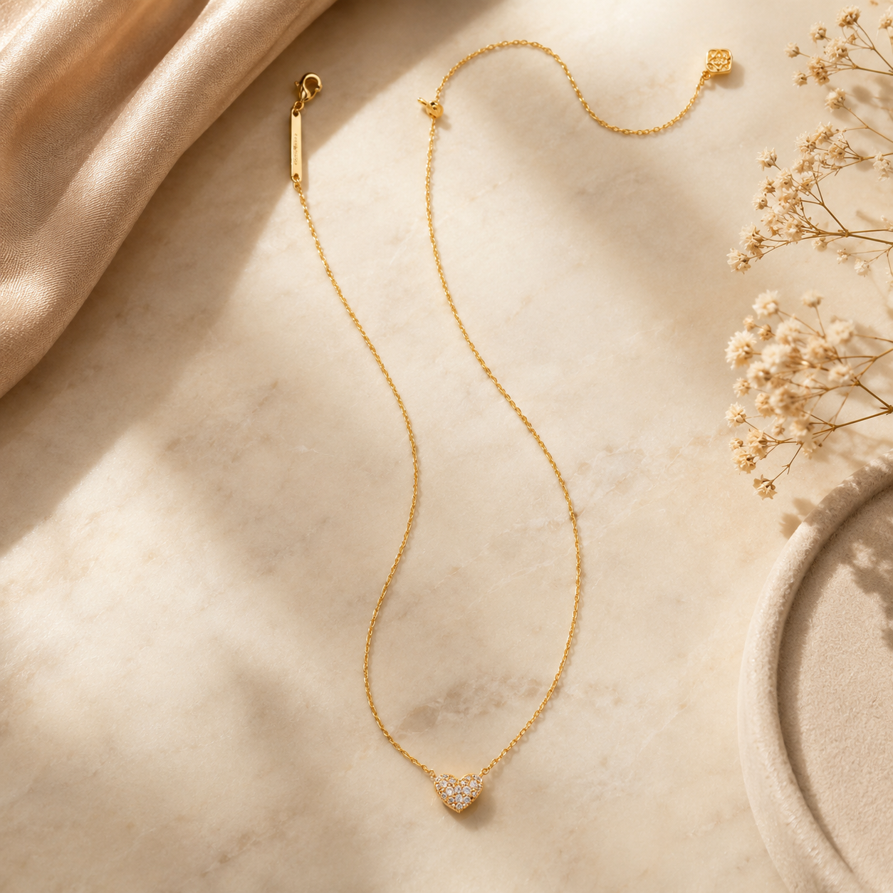 Kendra Scott Ari Pave Gold White Crystal Heart Necklace with delicate pavé crystal heart pendant on ivory marble luxury background