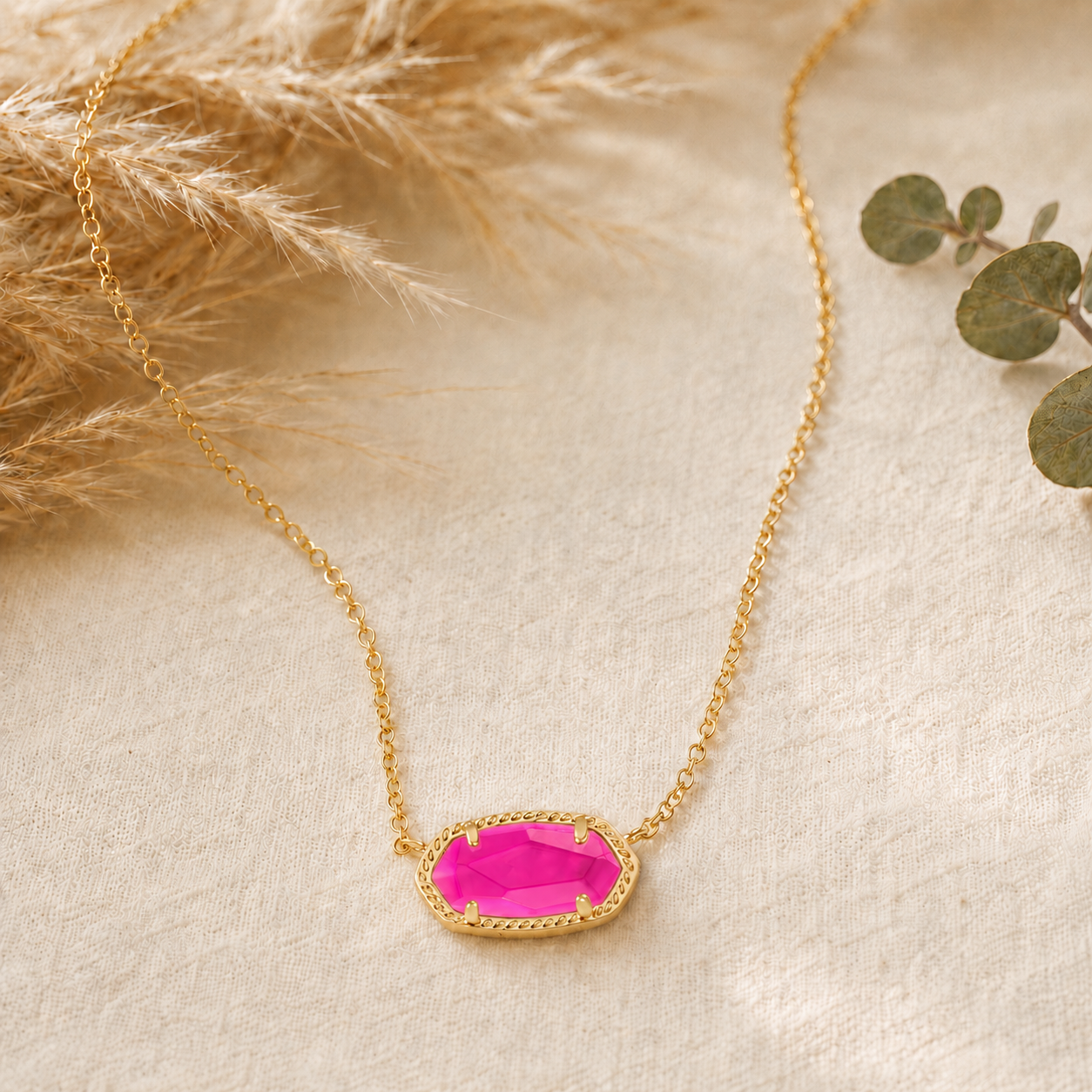 Kendra Scott Elisa Short Pendant Necklace in Gold Azalea Illusion with a vivid pink oval pendant on a delicate gold chain