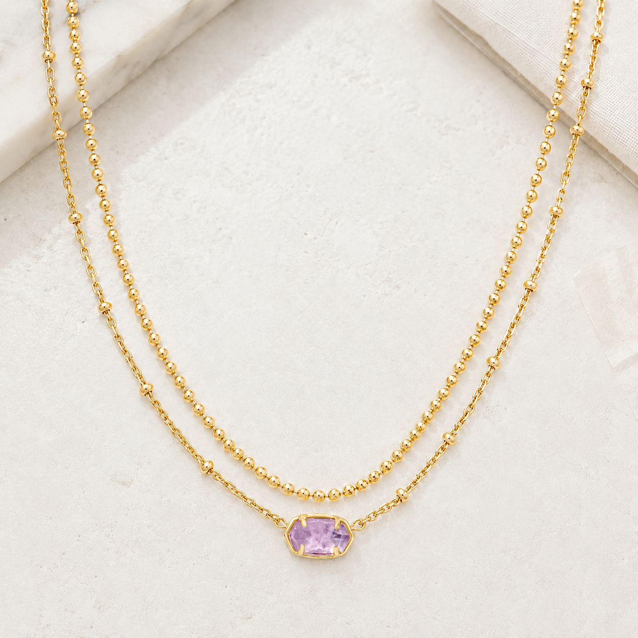 Kendra Scott Emilie Multi Strand Necklace in Gold Purple Amethyst with layered chains and faceted purple oval pendant