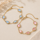 Kendra Scott Adriana Scallop Frame Delicate Chain Bracelet in sky blue and light pink iridescent abalone variants