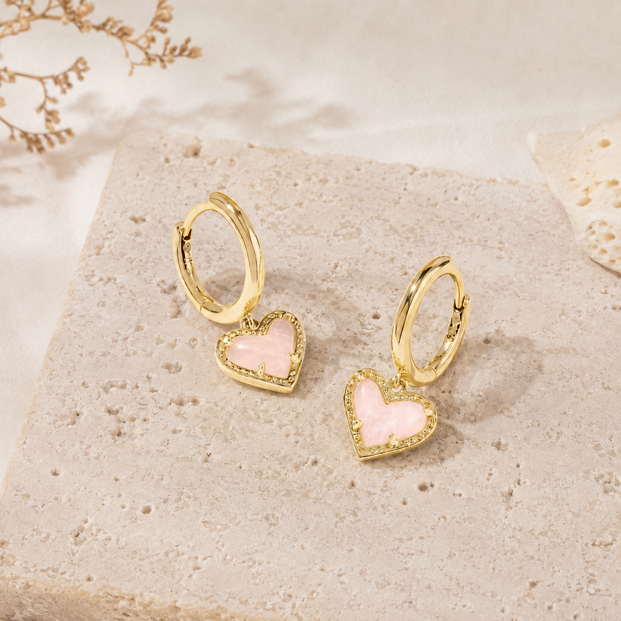 Kendra Scott Ari Heart Gold Huggie Earrings in genuine Rose Quartz with pink heart charms and hinge closure