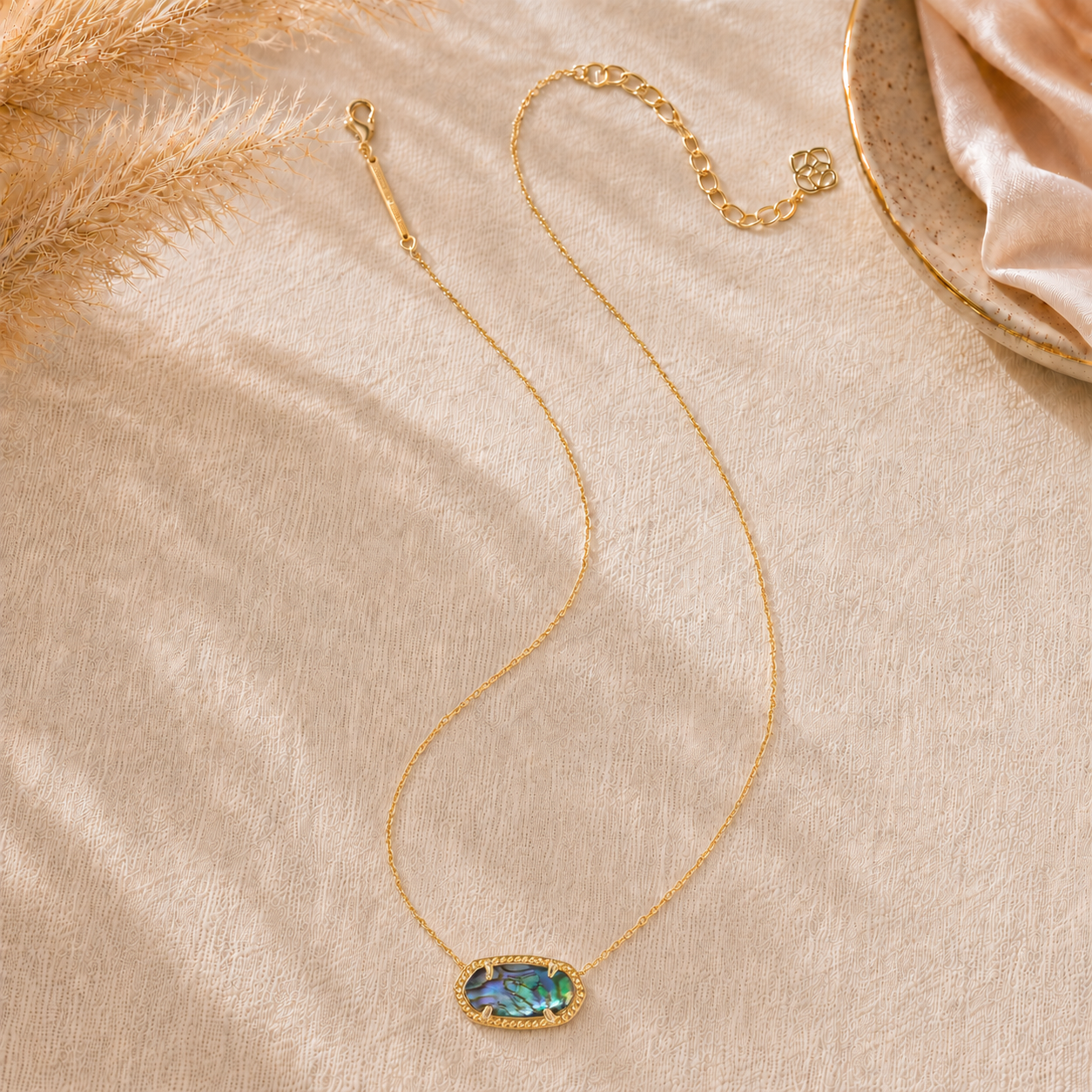 Full view of the Kendra Scott Elisa Gold Abalone Shell Pendant Necklace with adjustable gold chain and iridescent oval pendant