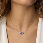 Kendra Scott Elisa Gold Dark Lavender Kyocera Opal Pendant Necklace worn on model with a vivid multicolor oval pendant