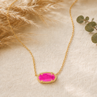 Kendra Scott Elisa Short Pendant Necklace in Gold Azalea Illusion with a vivid pink oval pendant on a delicate gold chain