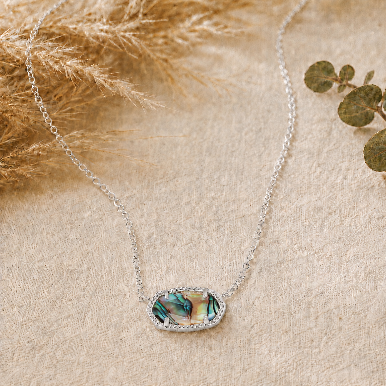 Kendra Scott Elisa Short Pendant Necklace in Rhodium Abalone Shell with an iridescent shell oval pendant on a delicate rhodium chain