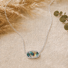 Kendra Scott Elisa Short Pendant Necklace in Rhodium Abalone Shell with an iridescent shell oval pendant on a delicate rhodium chain