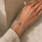 Kendra Scott Elton Cuff Bracelet in Rhodium Platinum Drusy worn on wrist with silver finish and glittering stones