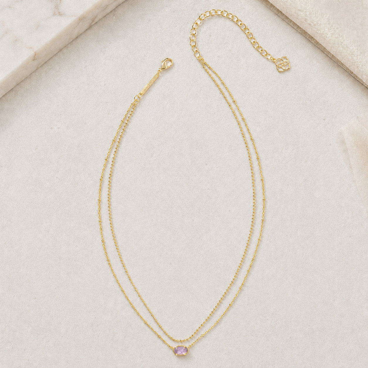 Kendra Scott Emilie Multi Strand Necklace in Gold Purple Amethyst with layered chains, Lobster clasp closure and faceted purple oval pendant