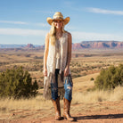 Madame Peacock's cream crochet lace vest with tie front and layered fringe hem. Boho style.