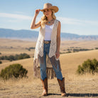Madame Peacock's cream crochet lace vest with tie front and layered fringe hem. Boho style.