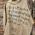 Trust Your Wings oversized tan hooded sweater front view