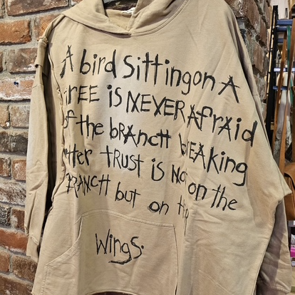 Trust Your Wings oversized tan hooded sweater front view